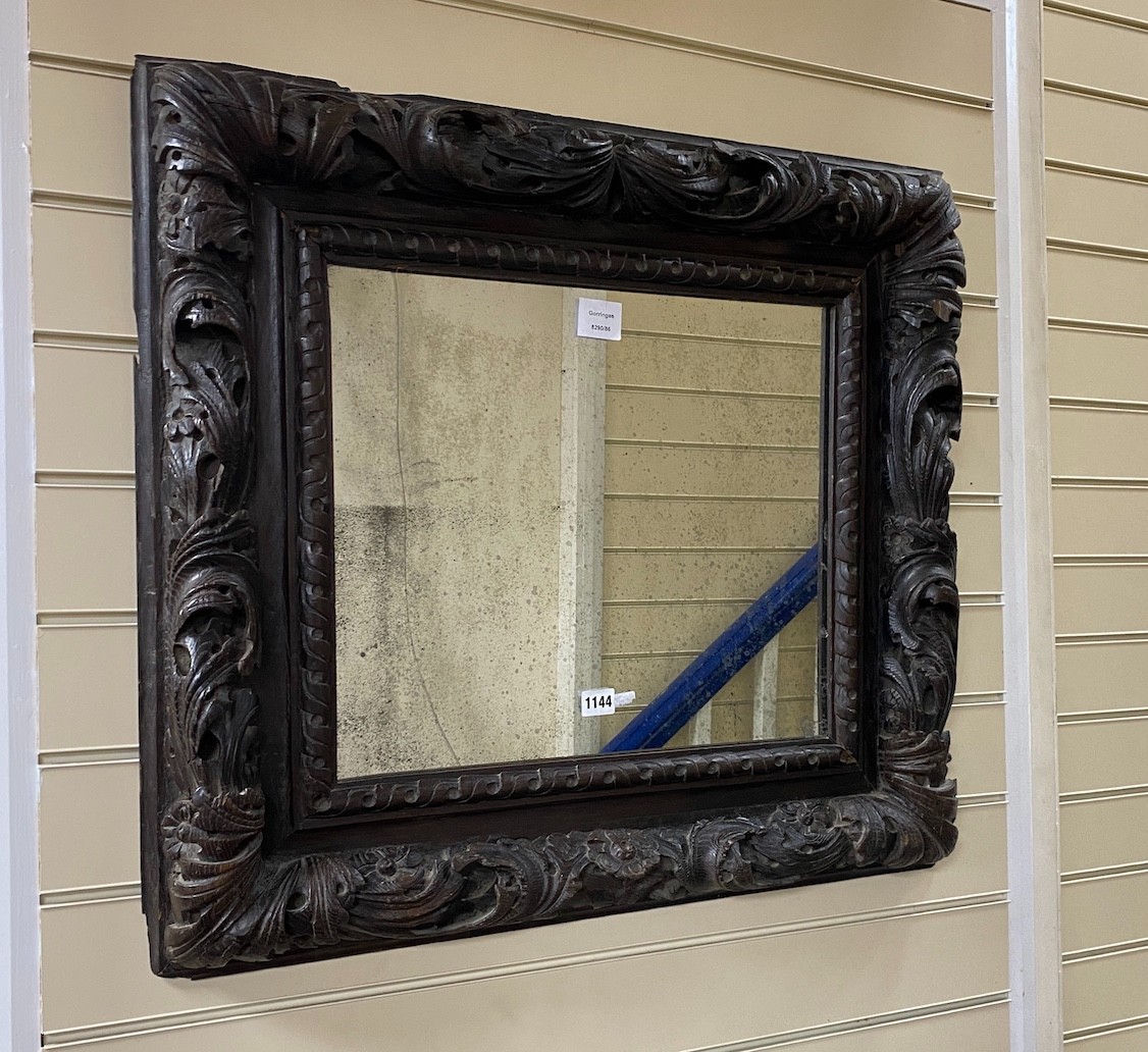 A late 17th century and later rectangular carved oak wall mirror with pierced scrolling acanthus frame width 74cm, height 66cm.